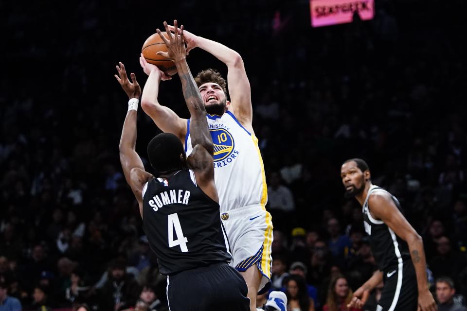 Brooklyn Nets' Edmond Sumner (4) defends a shot by Golden State Warriors' Ty Jerome (10) during the first half of an NBA basketball game Wednesday, Dec. 21, 2022 in New York. (AP Photo/Frank Franklin II)