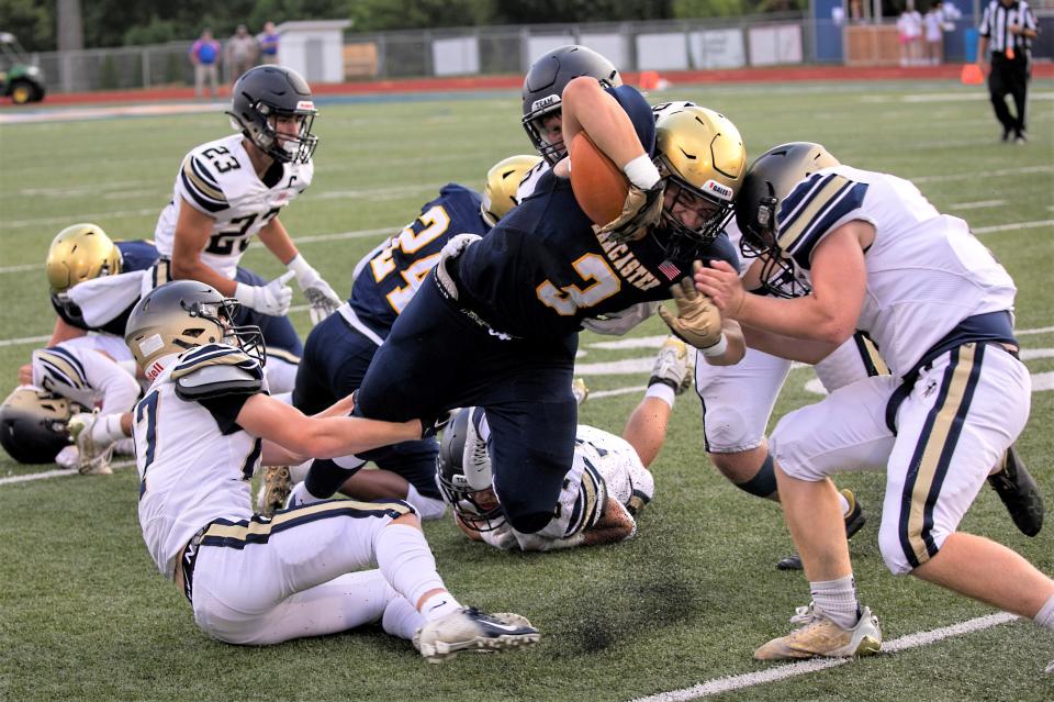 Lancaster's Xasvier Goss (3) Tries to gain more yardage braking through the Teays Valley defense during Division I High School football at Fulton Field on August 18, 2023, in Lancaster, Ohio.