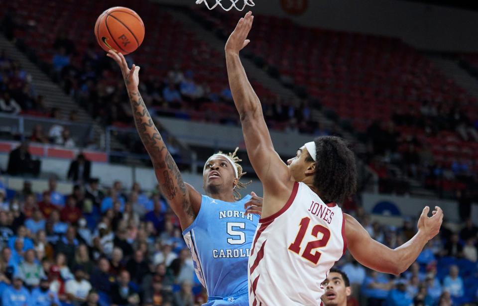 North Carolina forward Armando Bacot, left, shoots over Iowa State forward Robert Jones during the first half of an NCAA college basketball game in the Phil Knight Invitational tournament in Portland, Ore., Friday, Nov. 25, 2022. (AP Photo/Craig Mitchelldyer)