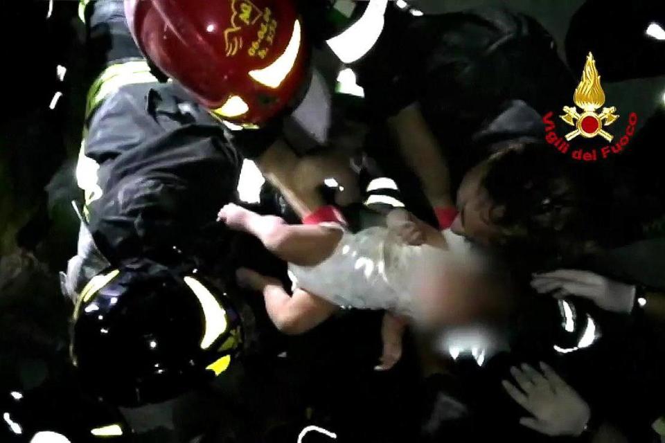 Baby: The infant being pulled from the rubble by a team of firemen