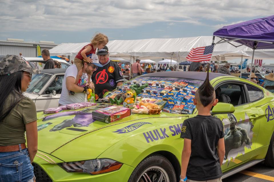 Festival-goers check out hot rods and classic cars at a previous Planes, Trains and Automobiles rally at the Plant City Airport.