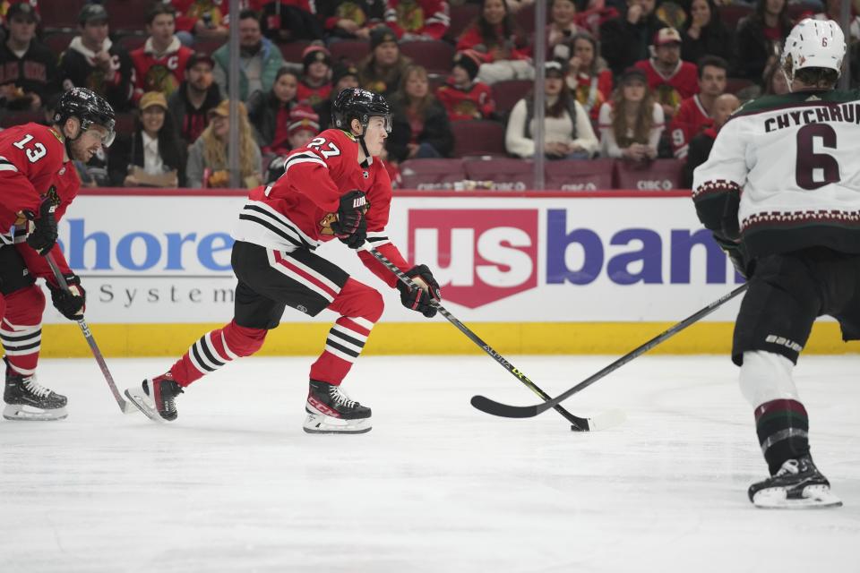 Chicago Blackhawks left wing Lukas Reichel (27) handles the puck during the second period of an NHL hockey game against the Arizona Coyotes, Friday, Jan. 6, 2023, in Chicago. (AP Photo/Erin Hooley)