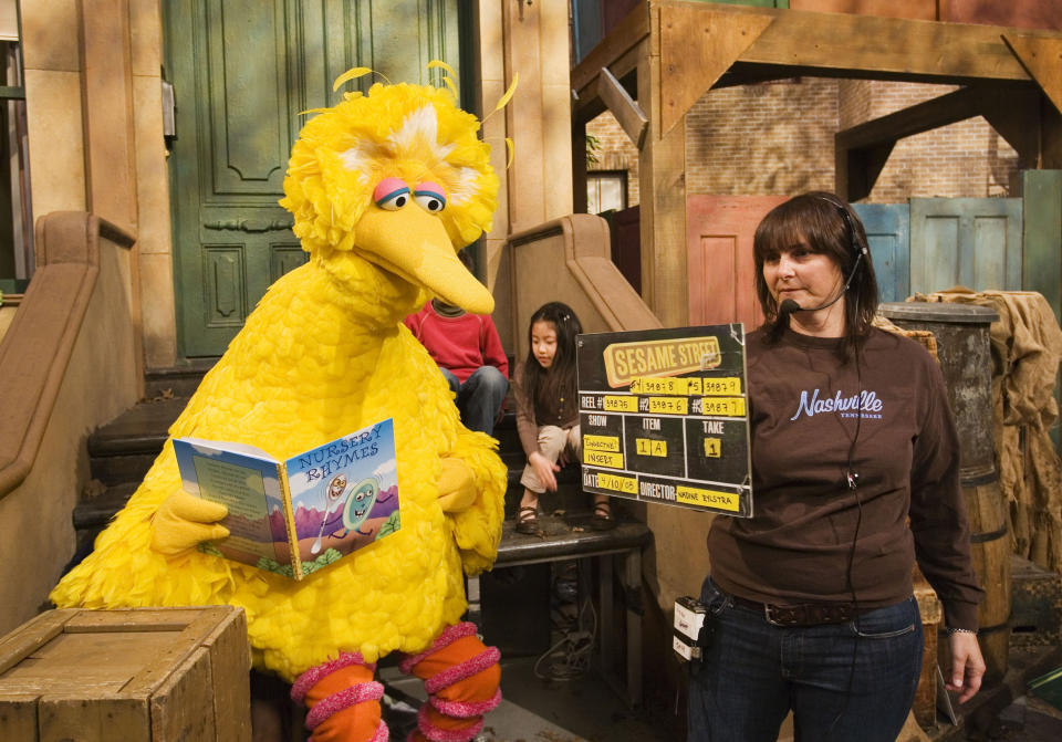 FILE - This April 10, 2008 file photo shows Lynn Finkel, stage manager for "Sesame Street," slates a taping with Big Bird, performed by Caroll Spinney, in New York. The popular children's TV show is celebrating its 50th year. (AP Photo/Mark Lennihan, File)