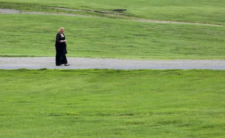 A Member of the Ohio Crisis Response Team walks towards Ohio State Route 73 after the funeral for six members of the Rhoden family, who were shot to death in rural Pike County on April 22, at Dry Run Church of Christ in West Portsmouth, Ohio, U.S. May 3, 2016. REUTERS/Kyle Grillot