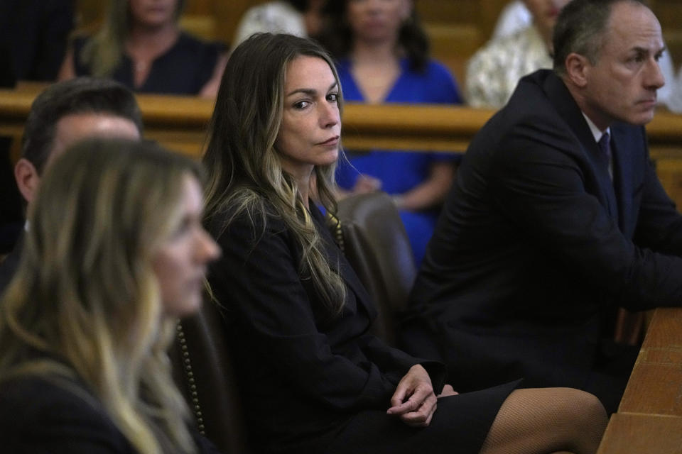 Karen Read watches as jurors are seated in court to continue with deliberations at the trial of Read at Norfolk Superior Court, Friday, June 28, 2024, in Dedham, Mass. Read, 44, is accused of running into her Boston police officer boyfriend with her SUV in the middle of a nor'easter and leaving him for dead after a night of heavy drinking. (AP Photo/Charles Krupa, Pool)