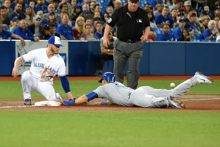 Sep 20, 2017; Toronto, Ontario, CAN; Kansas City Royals left fielder Alex Gordon (4) steals third base as the ball gets away from Toronto Blue Jays third baseman Josh Donaldson (20) in the second inning at Rogers Centre. Mandatory Credit: Dan Hamilton-USA TODAY Sports