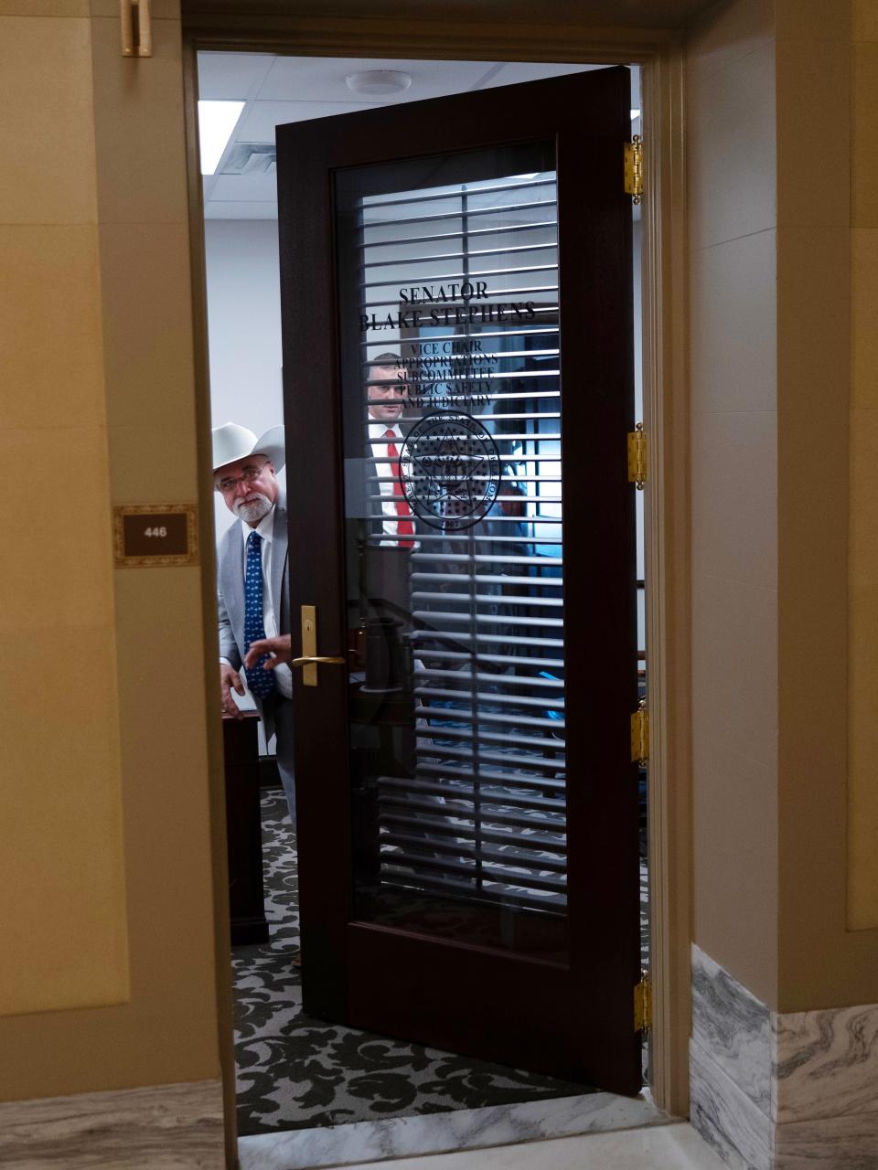 Sen. Tom Woods visits Monday with Sen. Blake Stephens in Stephens' office.