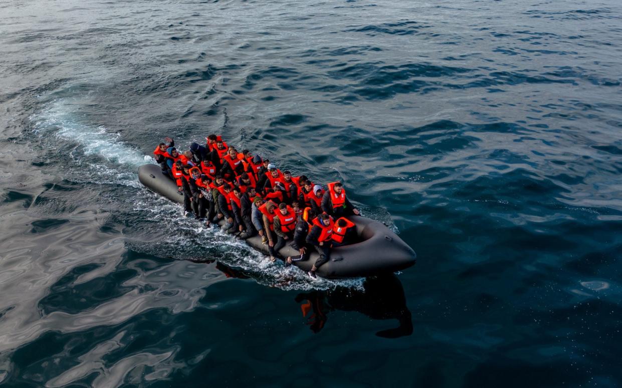 In this drone view an inflatable dinghy carrying migrants makes its way towards England in the English Channel
