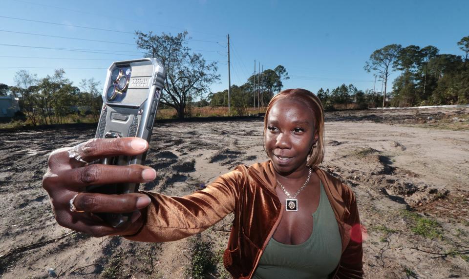 Lillie Lovett, a Daytona Beach resident who has received support from the Homes Bring Hope program, takes a selfie on the lot that will be the site of her family's new home. "I can't wait," she said. "I'm ready. I'm overly ready."
