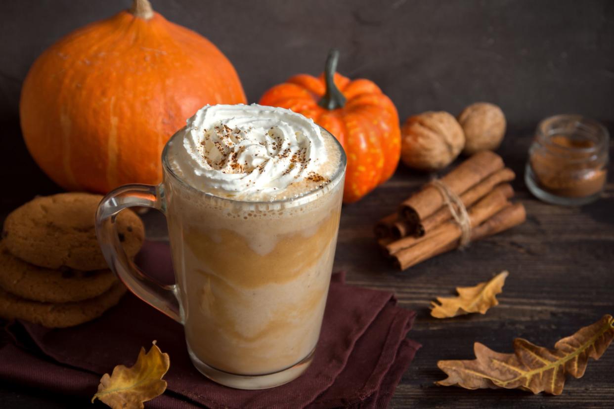 pumpkin spice latte with ingredients in background