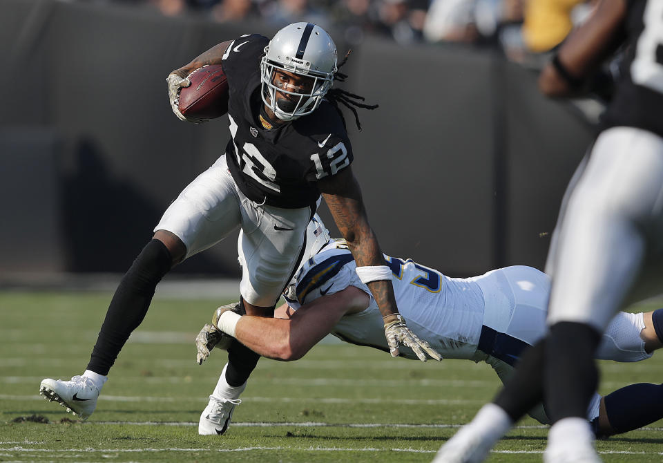 FILE - Oakland Raiders wide receiver Martavis Bryant (12) runs against Los Angeles Chargers linebacker Kyle Emanuel during the first half of an NFL football game in Oakland, Calif., Sunday, Nov. 11, 2018. The Dallas Cowboys signed receiver Martavis Bryant to their practice squad Wednesday, Nov. 8, 2023, ending a five-year absence from the NFL for a player who has been suspended three times.(AP Photo/John Hefti, File)