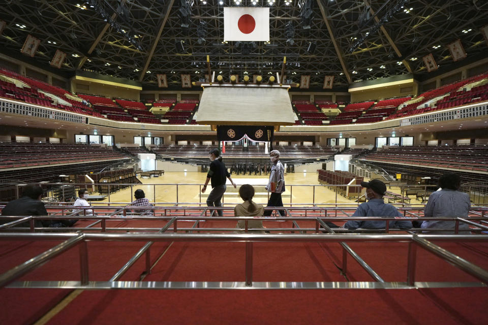 Elderly residents of Sumida Ward rest at box seats after receiving their first dose of Pfizer's COVID-19 vaccine at the Ryogoku Kokugikan sporting arena, in Tokyo Monday May 24, 2021. The arena, mainly used for sumo wrestling tournaments, is used as temporary inoculation venue for local residents age over 65 years old. (AP Photo/Eugene Hoshiko)