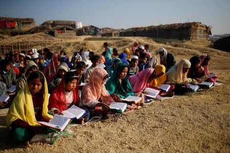 Rohingya refugee children attend an open air Arabic school at Kutupalang Unregistered Refugee Camp, where they learn to read the Quran, in Cox's Bazar, Bangladesh, February 4, 2017. REUTERS/Mohammad Ponir Hossain/Files