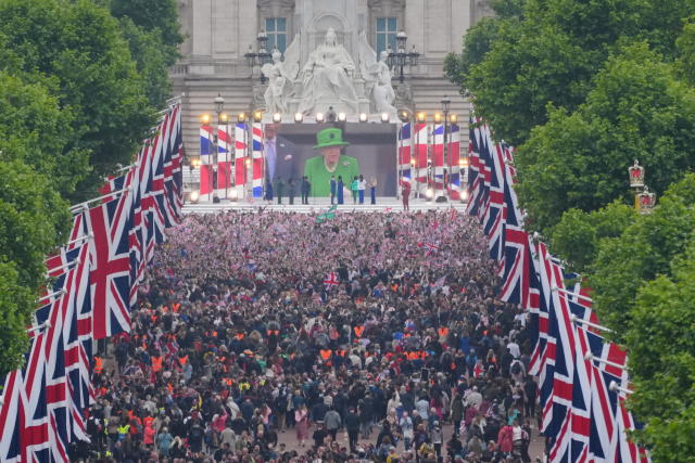 Crowds are seen on The Mall with Queen Elizabeth II shown on a screen during the singing of the National Anthem at the Platinum Jubilee Pageant in front of Buckingham Palace, London, on day four of the Platinum Jubilee celebrations. Picture date: Sunday June 5, 2022.