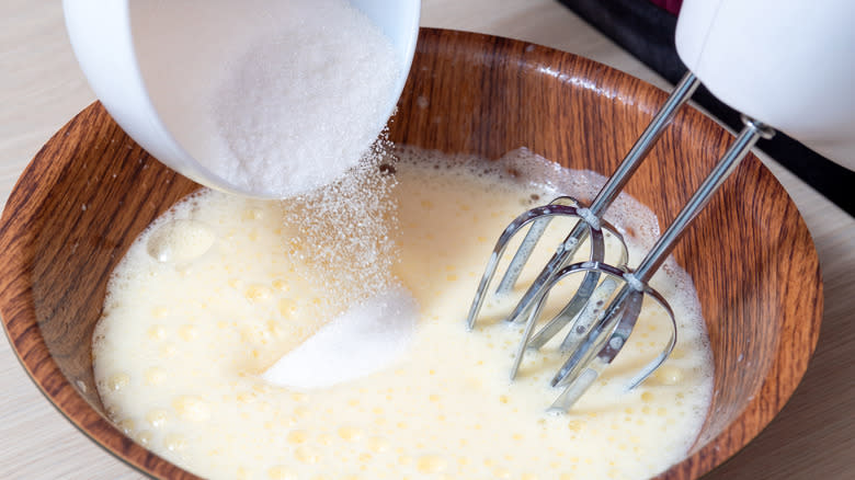 Beating eggs and sugar in bowl