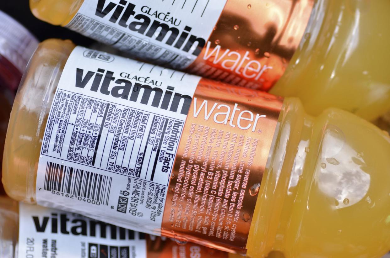 Closeup of three bottles of orange Glacéau Vitaminwater