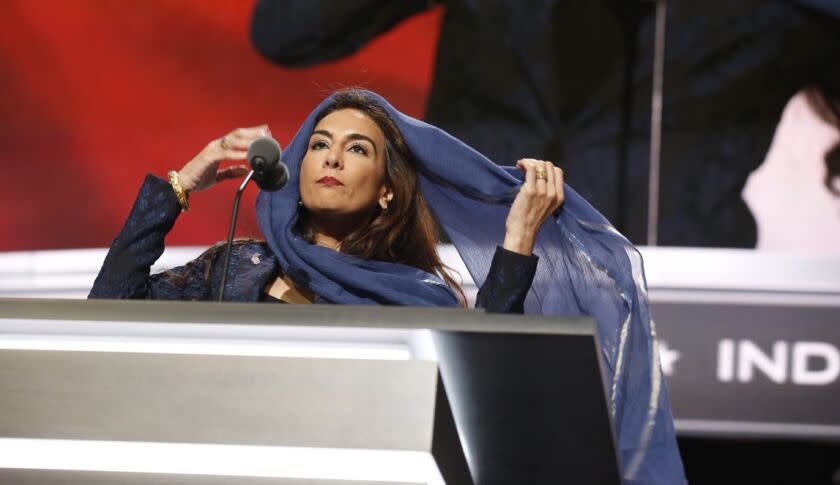 Harmeet Dhillon covers her hair as she conducts the invocation during the second day of the Republican National Convention in Cleveland, Tuesday, July 19, 2016.