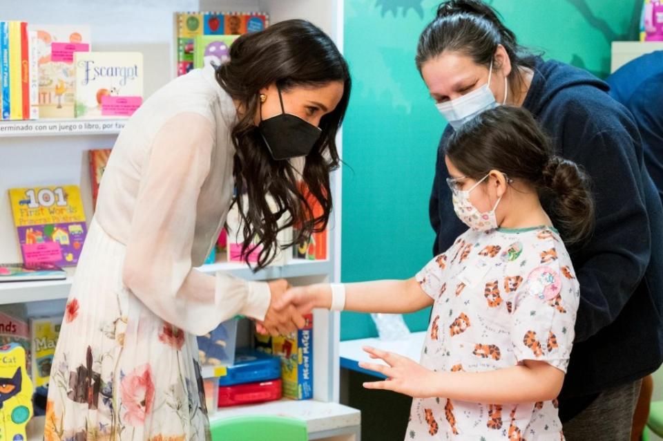 Meghan Markle (left) greeted a sick child during her appearance. Childrens Hospital Los Angeles