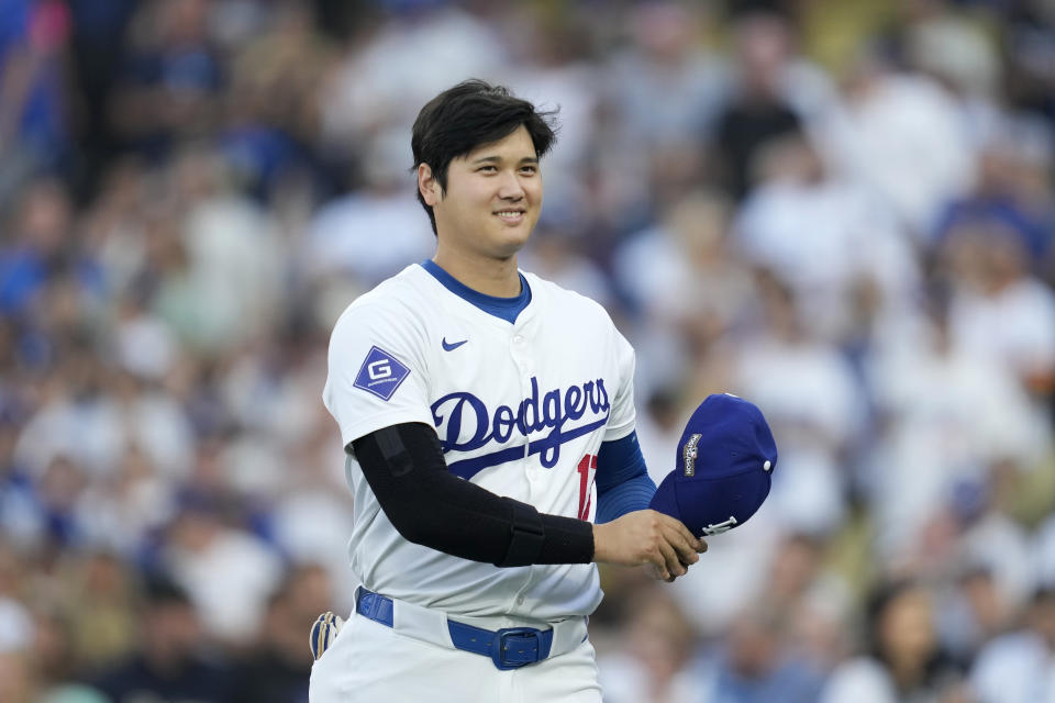 Los Angeles Dodgers' Shohei Ohtani walks back to the dugout before Game 1 of baseball's NL Division Series against the San Diego Padres, Saturday, Oct. 5, 2024, in Los Angeles. (AP Photo/Ashley Landis)