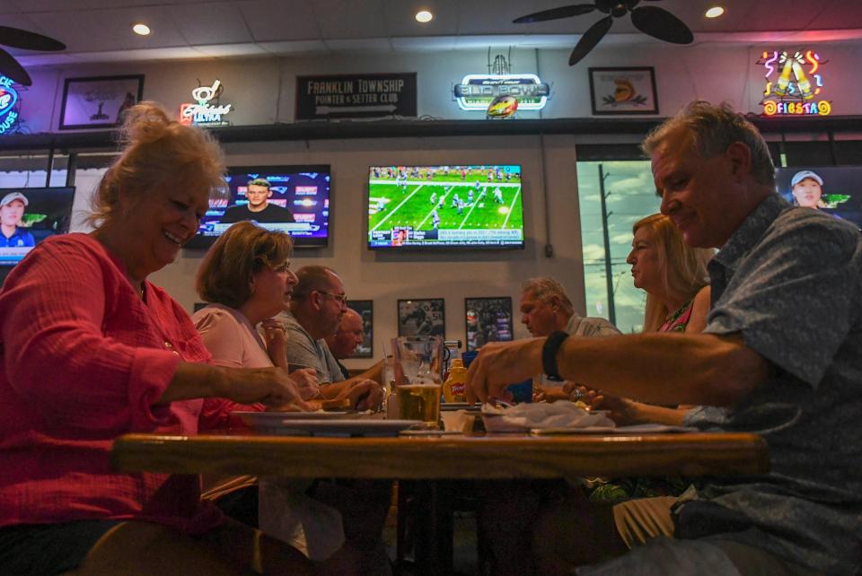 Customers and staff enjoy a fun evening during burger night at the St. Lucie Draft House on Wednesday, Aug. 31, 2022, in Port St. Lucie.