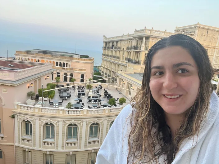 A woman taking a selfie in front of European looking buildings.