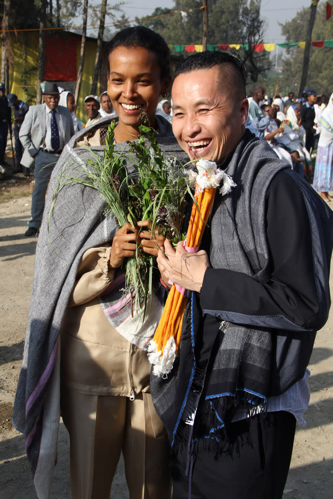 “Liya and Phillip pose with their recent purchase of beeswax candles and frankincense.”