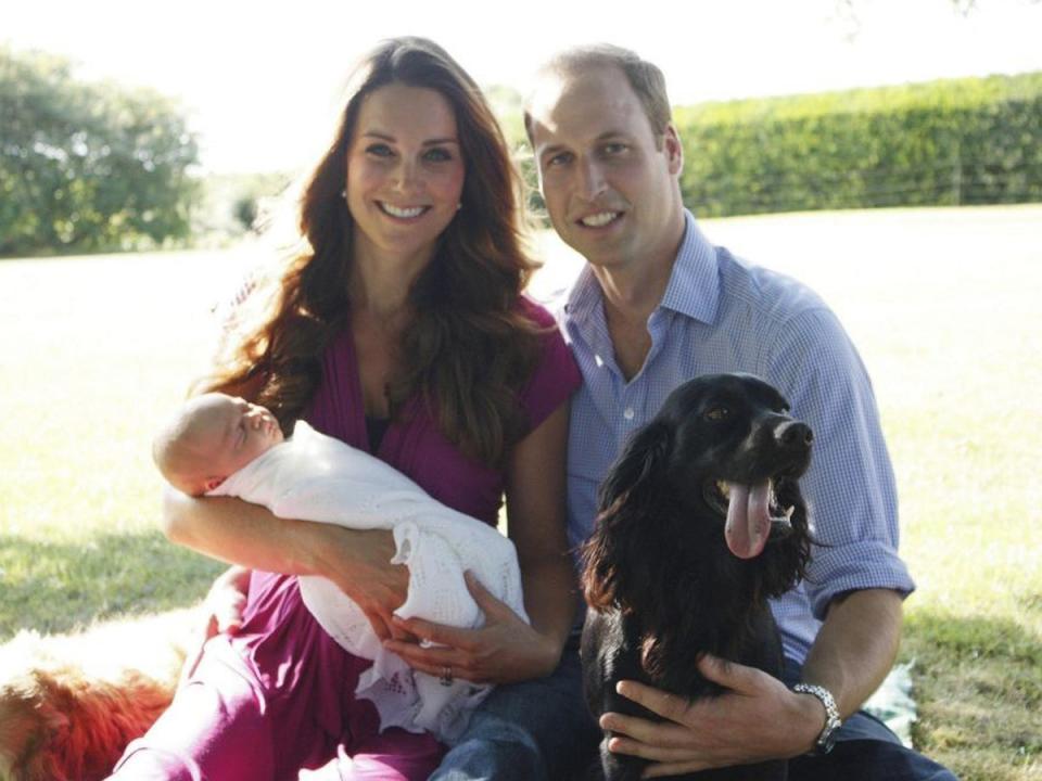 The photo taken by Michael Middleton, the Duchess's father, of the Duke and Duchess of Cambridge as they sit with their son Prince George and cocker spaniel Lupo in the garden of the Middleton family home in Bucklebury, Berkshire (TRH The Duke and Duchess of Cambridge 2013/Press Association)