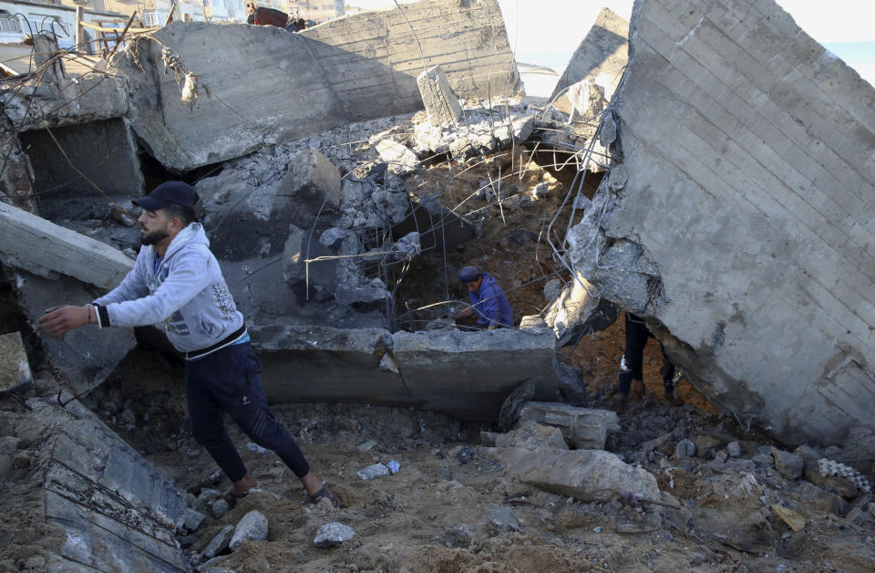 Residents remove rubble of destroyed sewage pipes following overnight Israeli missile strikes, along the beach of Shati refugee camp, in Gaza City, Thursday, Feb. 6, 2020. Earlier on Wednesday, Israel struck Hamas militant targets in Gaza in response to rocket fire toward Israeli communities the previous night. (AP Photo/Adel Hana)