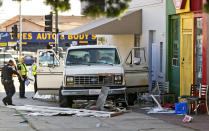 <p>An official looks at a van that plowed into a group of people on a Los Angeles sidewalk Sunday, July 30, 2017. A witness to the crash told The Associated Press the van jumped a curb and careened into a group of people eating outside The Fish Spot restaurant in the city’s Mid-Wilshire neighborhood. The cause of the crash is under investigation. (AP Photo/Damian Dovarganes) </p>