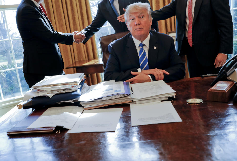 FILE - President Donald Trump sits at his desk after a meeting with Intel CEO Brian Krzanich, left, and members of his staff in the Oval Office of the White House in Washington, Feb. 8, 2017, as a lockbag is visible on the desk, the key still inside at left. Sen. Martin Heinrich, D-N.M., all but warned of Trump's handling of sensitive documents early in the then-president’s term. “Never leave a key in a classified lockbag in the presence of non-cleared people. #Classified101,” tweeted Heinrich, a member of the Intelligence Committee, days after the February 2017 incident. He asked for a review. (AP Photo/Pablo Martinez Monsivais, File)