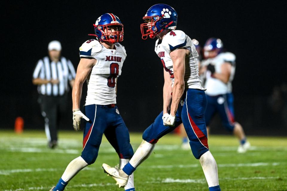 Mason's Kaleb Parrish, right, celebrates with Derek Badgley after breaking up a Williamston pass on fourth down during the fourth quarter on Friday, Sept. 16, 2022, in Williamston.