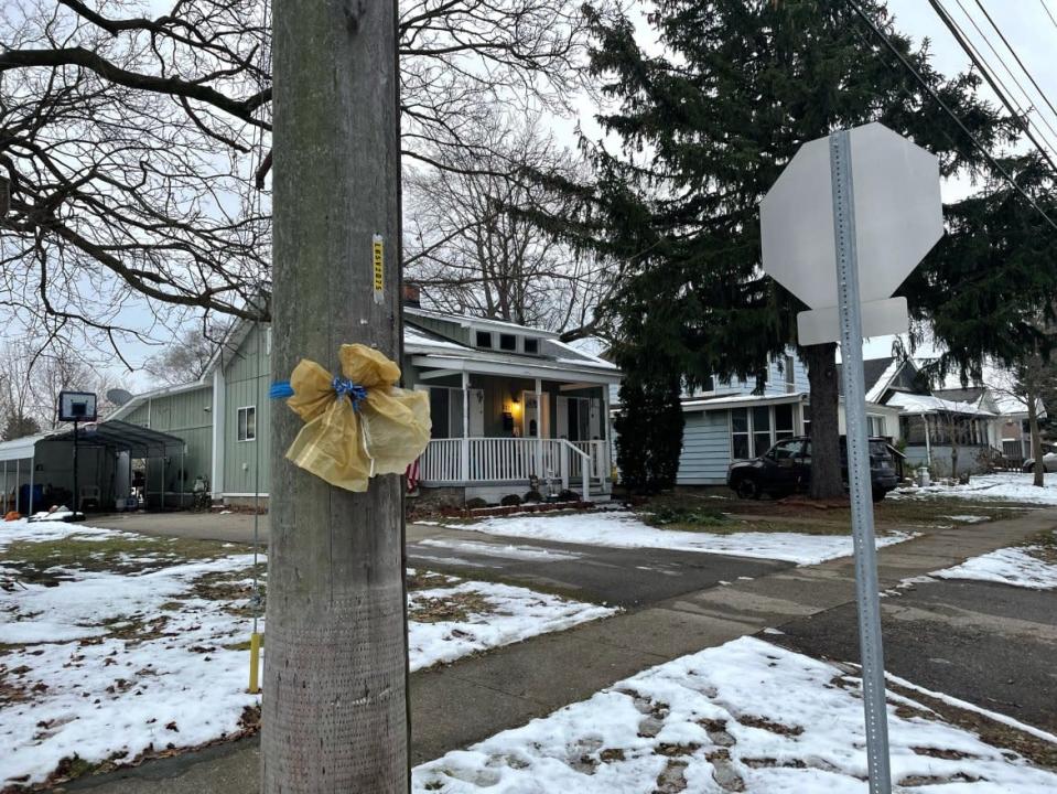 <div class="inline-image__caption"><p>A ribbon hanging in front of the alleged gunman’s family home.</p></div> <div class="inline-image__credit">Allie Gross</div>