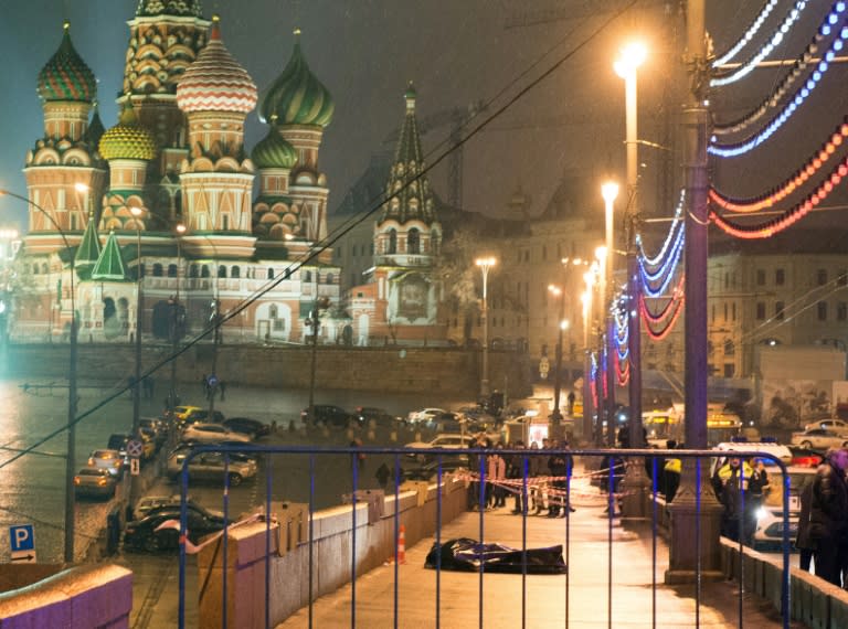 The body of Russian opposition leader Boris Nemtsov lies covered with plastic on Moskvoretsky bridge near St. Basil cathedral (background) in central Moscow