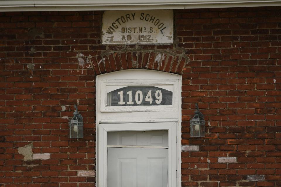 The marker of the original 1912 Luna Pier Victory School is visible. The building was decommissioned as a school in 1936 and has been a private residence ever since.