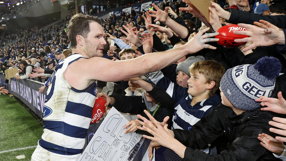 Patrick Dangerfield high-fives fans.