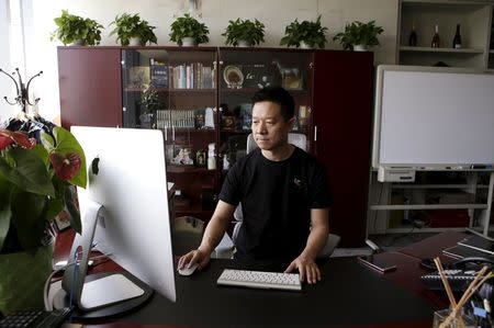 Jia Yueting, co-founder and head of Le Holdings Co Ltd, also known as LeEco and formerly as LeTV, uses a computer as he poses for a photo at his president office after a Reuters interview at LeEco headquarters in Beijing, China, picture taken April 22, 2016. REUTERS/Jason Lee