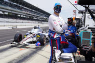 Graham Rahal waits next to his car in the opening 30 minutes of practice for the Indianapolis 500 auto race at Indianapolis Motor Speedway in Indianapolis, Friday, May 21, 2021. IndyCar has punished Rahal Letterman Lanigan for trying to stage a photo in the opening minutes of Thursday's practice and were force to sit out the first 30 minutes of practice on Friday. (AP Photo/Michael Conroy)