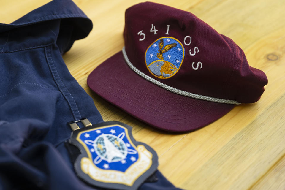 Portions of Air Force Capt. Jason Jenness' uniform are displayed on a table during an interview with the Associated Press in Missoula, Mont., on Saturday, Aug., 26, 2023. Capt. Jenness was a Malmstrom missileer who died of non-Hodgkin lymphoma in 2001 at the age of 31.(AP Photo/Tommy Martino)