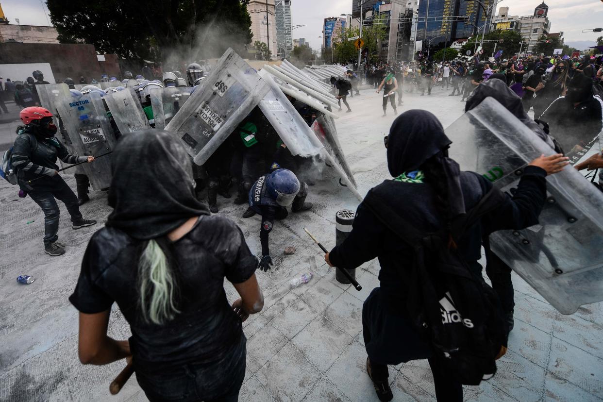 <p>Protesters clash with the police during a demonstration to commemorate the International Women's Day in Mexico City</p> (AFP via Getty Images)