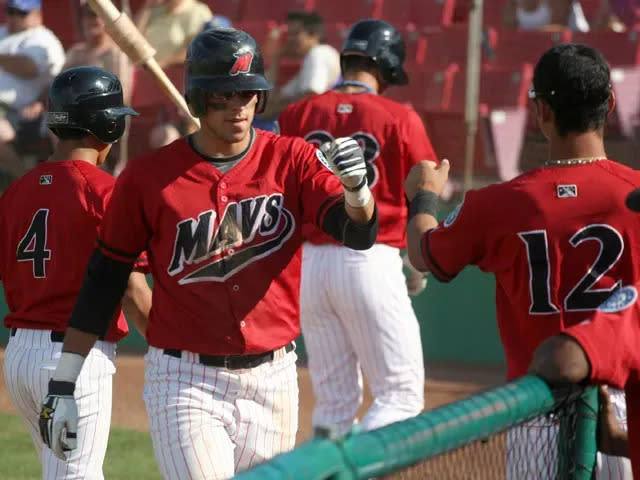 High Desert Mavericks third baseman Alex Liddi fist bumps Edilio Colina after scoring a run during a game in 2009. Liddi was was among eight players selected in the first round of the inaugural draft of a Dubai-based baseball league.