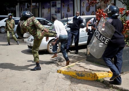 Kenyan policemen beat a protester during clashes in Nairobi, Kenya May 16, 2016. REUTERS/Goran Tomasevic/File Photo