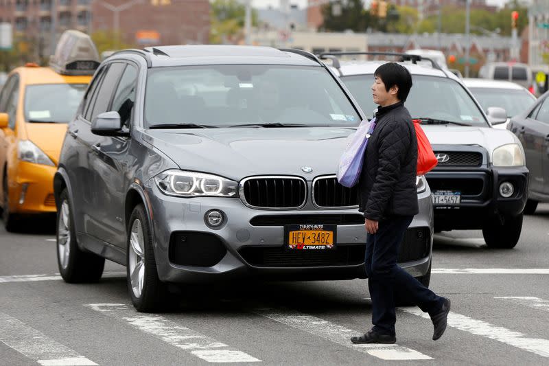 FILE PHOTO: A woman walks across a crosswalk along Queens Boulevard in the borough of Queens in New York, U.S., May 5, 2016.