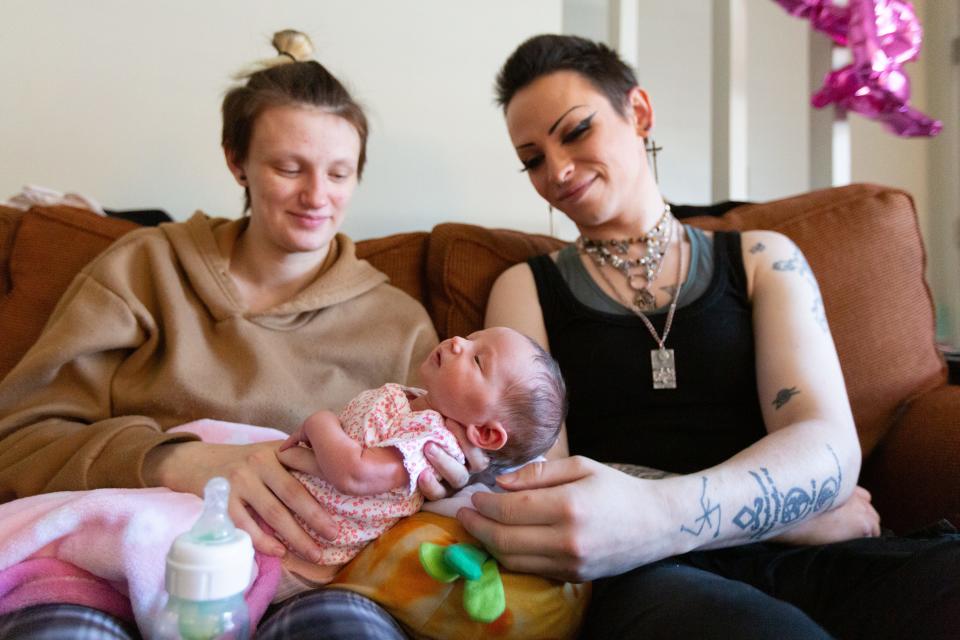 Austin Dalton, left, and Serana Darkmoon hold their 1-week-old newborn, Delilah Saphire, on Monday morning. Dalton and Darkmoon are transgender residents in Topeka who hope their story resonates with other parents.