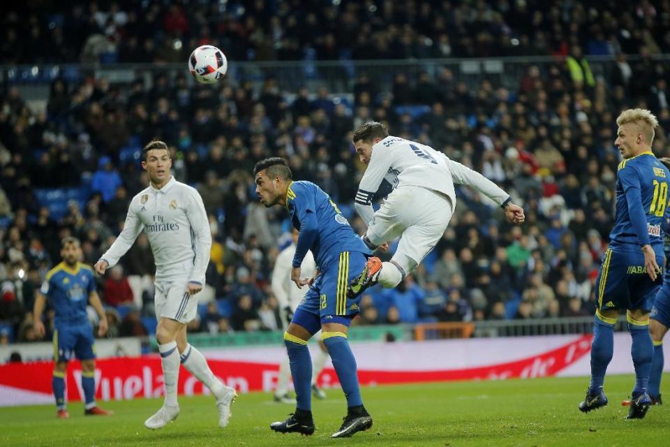 Real Madrid's Sergio Ramos, center right, heads a ball on goal during a Copa del Rey, quarterfinal, 1st leg soccer match between Real Madrid and Celta at the Santiago Bernabeu stadium in Madrid, Spain Wednesday Jan. 18, 2017. (AP Photo/Paul White)