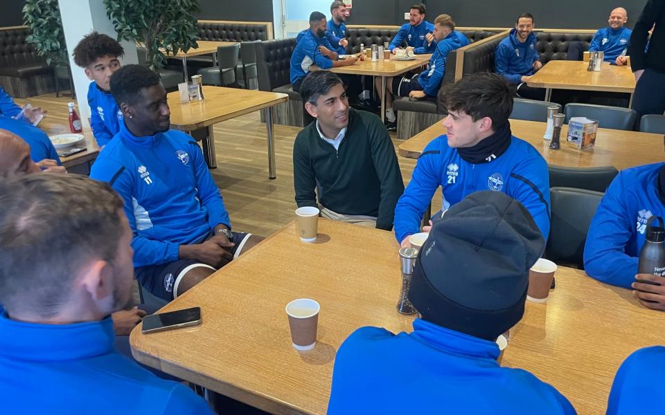 Prime Minister Rishi Sunak is pictured this morning meeting members of the Eastleigh football team during a visit to the Silverlake Stadium, in Eastleigh, Hampshire