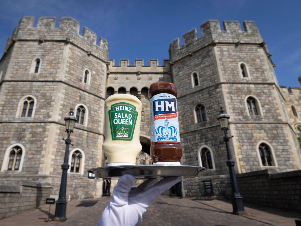 Two Heinz bottles pictured on a silver tray in front of Windsor Castle.