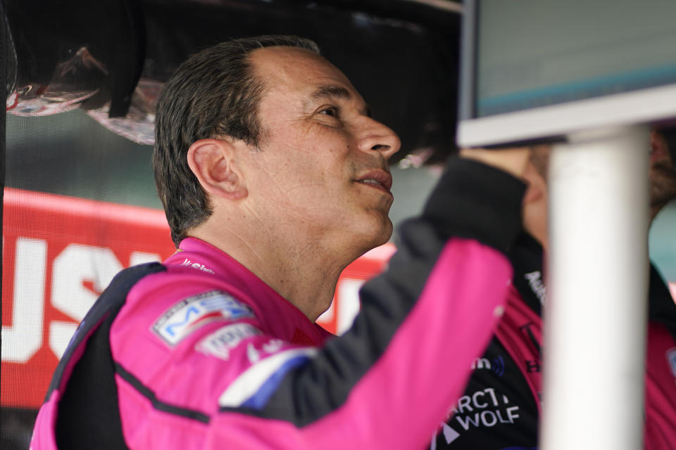 Helio Castroneves, of Brazil, looks at the results from practice for the IndyCar auto race at Indianapolis Motor Speedway, Friday, May 13, 2022, in Indianapolis. (AP Photo/Darron Cummings)