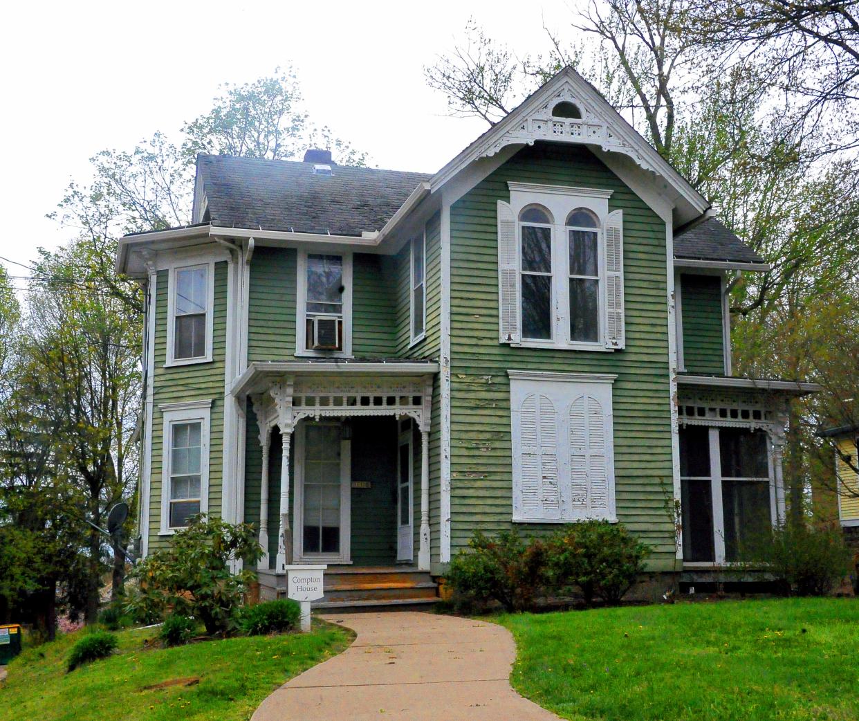 The Compton home on College Avenue. It is surrounded by a college parking lot on two sides. According to students, a house once stood in the lot directly south of the house before it was demolished.