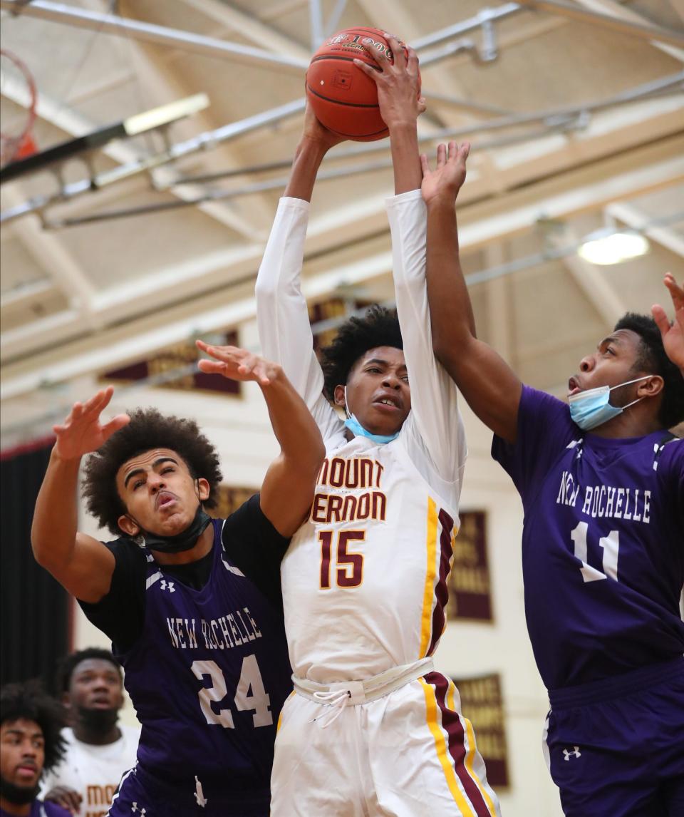 Mount Vernon's Brandon Sinclair (15) pulls in a rebound during their 72-47 win over New Rochelle in boys basketball action at Mount Vernon High School in Mount Vernon on Saturday, January 22, 2022. 
