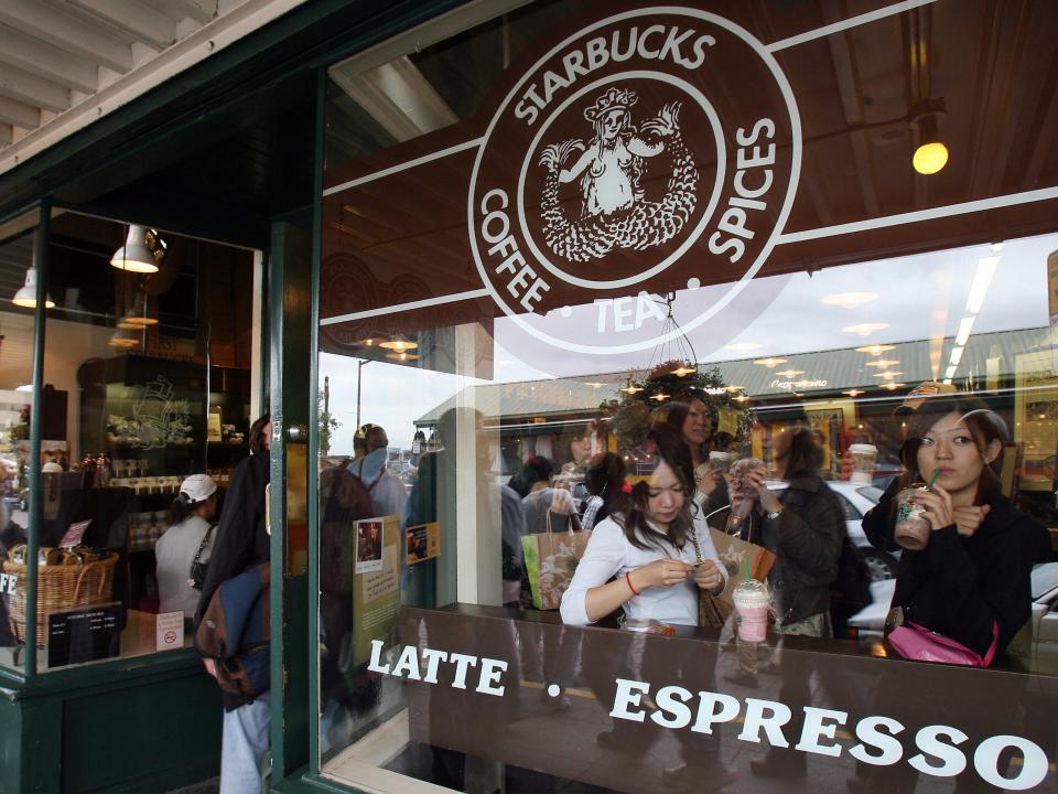 a window looks into the first starbucks coffee location in seattle washington